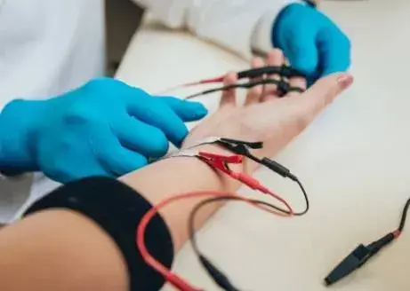 electromyography test picture depicting a doctor performing an electromyography test on a patient