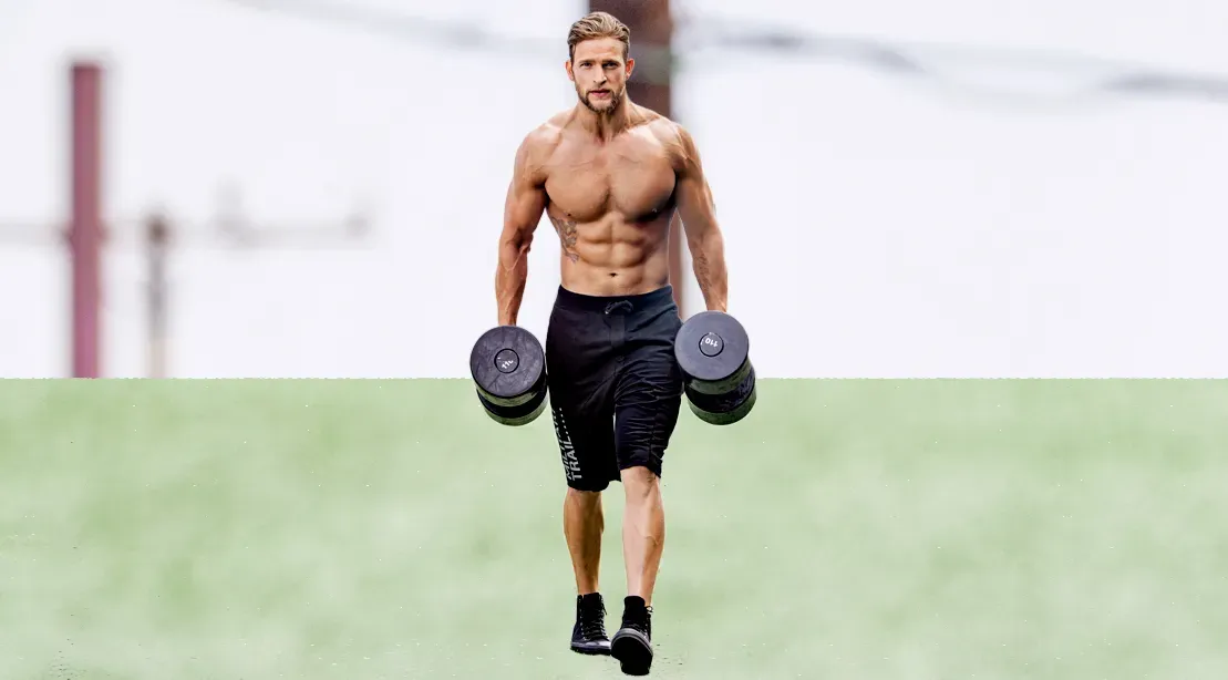 man doing farmer carries with dumbbells